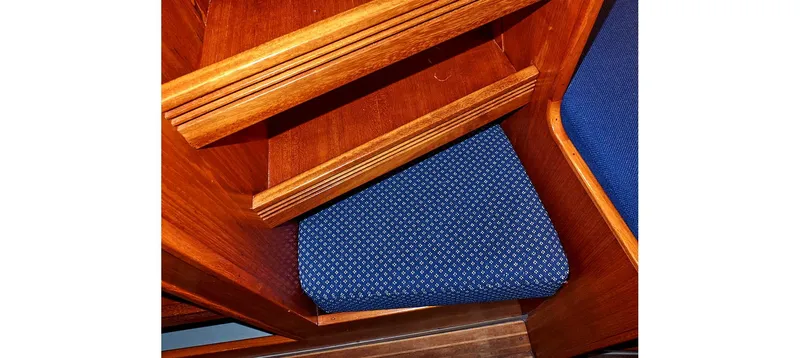 Slide: The Image of Wooden interior with blue cushioned seating on a 1980 Sceptre 36 Brandywine boat. - 46