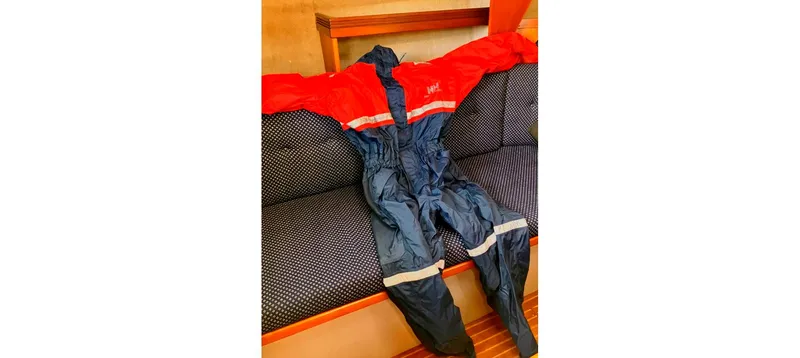 Slide: The Image of Red and blue waterproof suit on a patterned couch, Sceptre 36 Brandywine, 1980. - 48