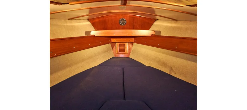 Slide: The Image of Interior of 1980 Sceptre 36 Brandywine sailboat with wooden accents and blue cushions. - 6
