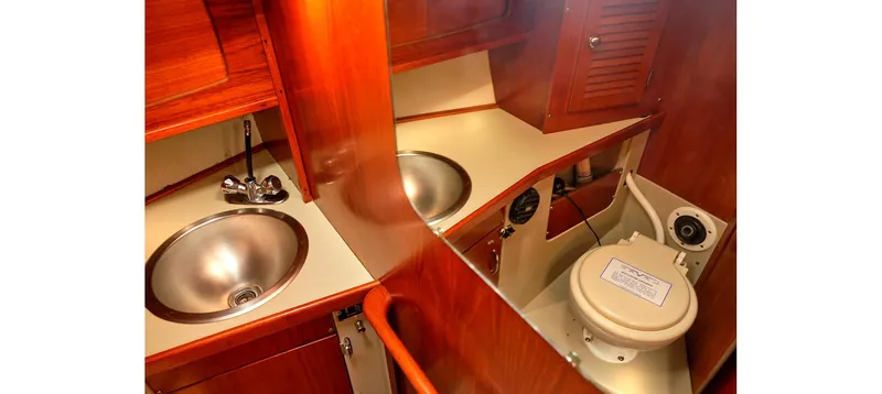 Slide: The Image of 1980 Sceptre 36 Brandywine yacht bathroom with wooden cabinetry and stainless steel sink. - 8