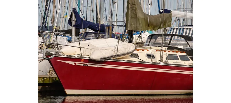 Slide: The Image of Red 1980 Sceptre 36 Brandywine sailboat docked in marina with other boats. - 82