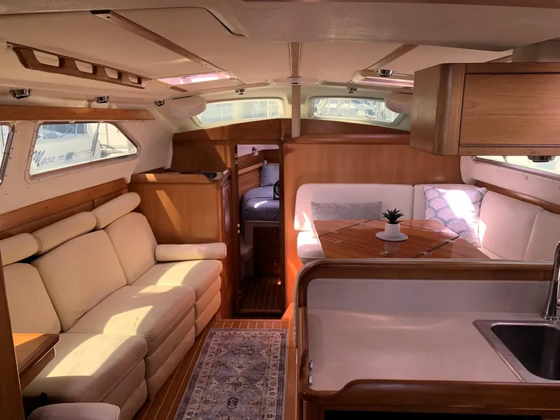 Slide: The Image of Luxurious interior of a 2007 Catalina Morgan 440 yacht with elegant seating and dining area. - 16
