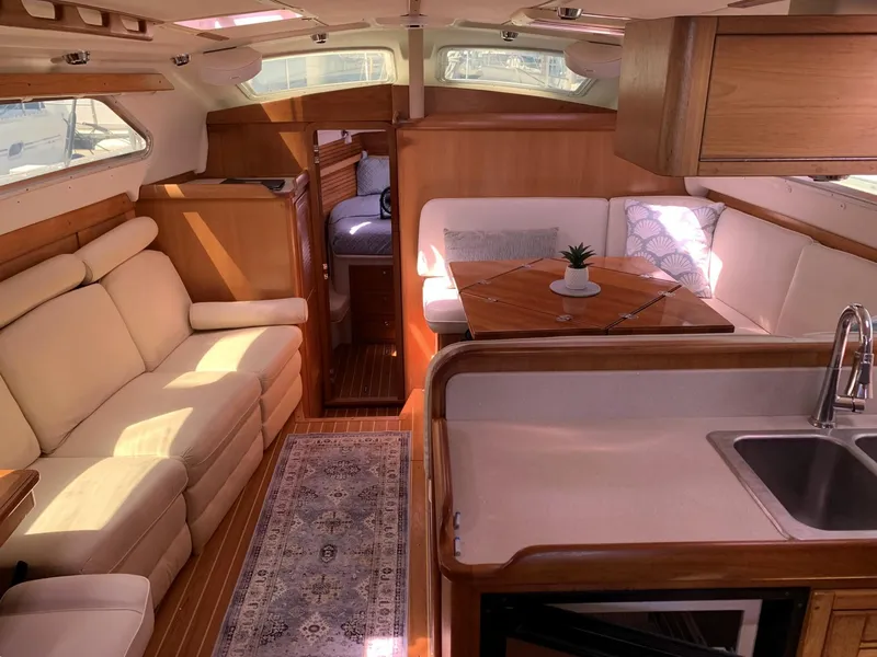 Slide: The Image of Luxurious 2007 Catalina Morgan 440 yacht interior with cozy seating and elegant wood finishes. - 17