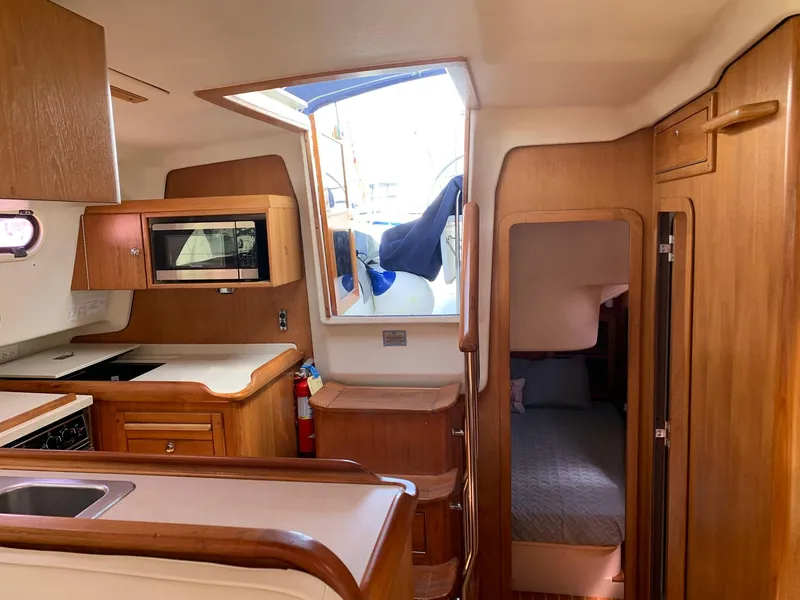 Slide: The Image of Interior of 2007 Catalina Morgan 440 yacht with kitchen and cozy cabin. - 21