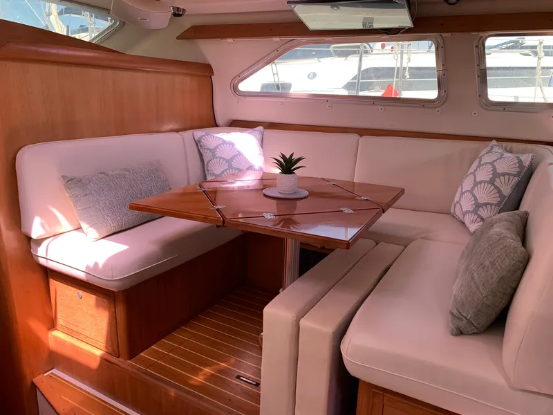 Slide: The Image of Luxurious 2007 Catalina Morgan 440 yacht interior with cozy seating and elegant wooden table. - 24