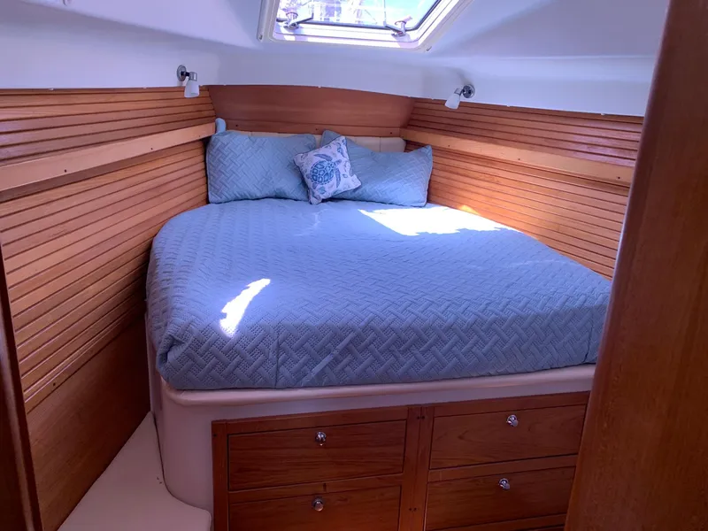 Slide: The Image of Cozy cabin interior of 2007 Catalina Morgan 440 sailboat with wooden accents and skylight. - 25