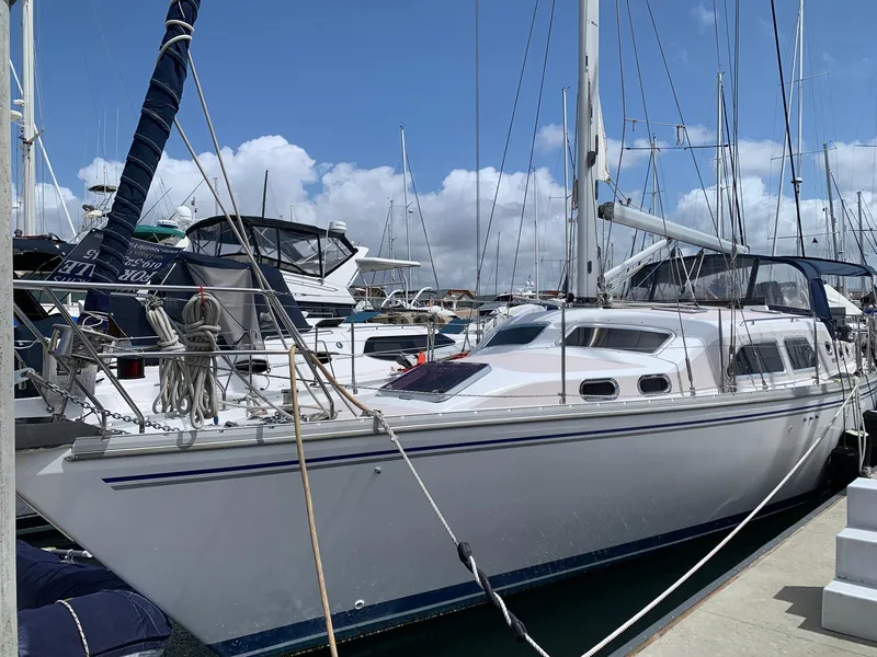 Slide: The Image of 2007 Catalina Morgan 440 sailboat docked at marina under blue sky. - 3