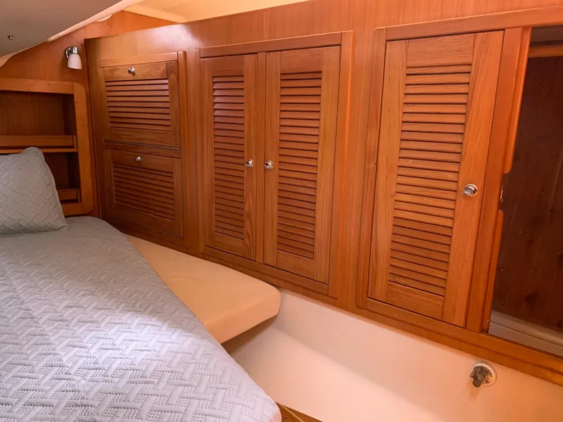Slide: The Image of Interior cabin of 2007 Catalina Morgan 440 with wooden cabinets and bed. - 30