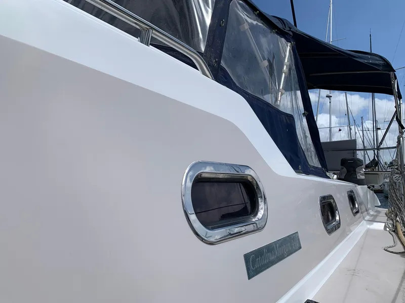 Slide: The Image of 2007 Catalina Morgan 440 yacht, side view with windows and canopy, docked at marina. - 8