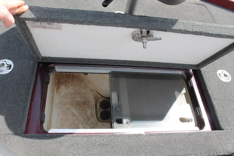 Slide: The Image of Open storage compartment in 2015 Ranger Z518C Comanche boat, showing interior details. - 17
