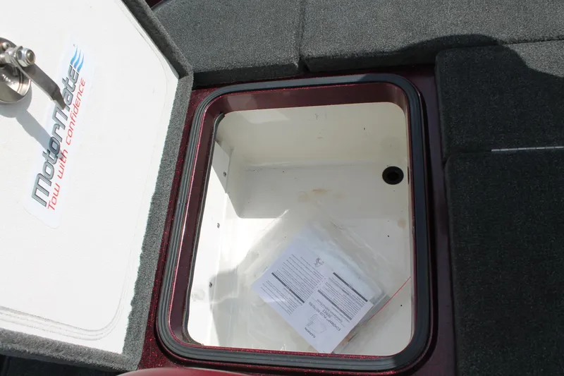 Slide: The Image of Open storage compartment in 2015 Ranger Z518C Comanche boat, featuring MotorMate branding. - 18