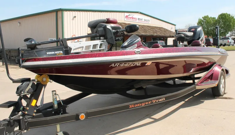 Slide: The Image of 2015 Ranger Z518C Comanche boat on trailer at dealership, featuring Minn Kota Ultrex motor. - 4
