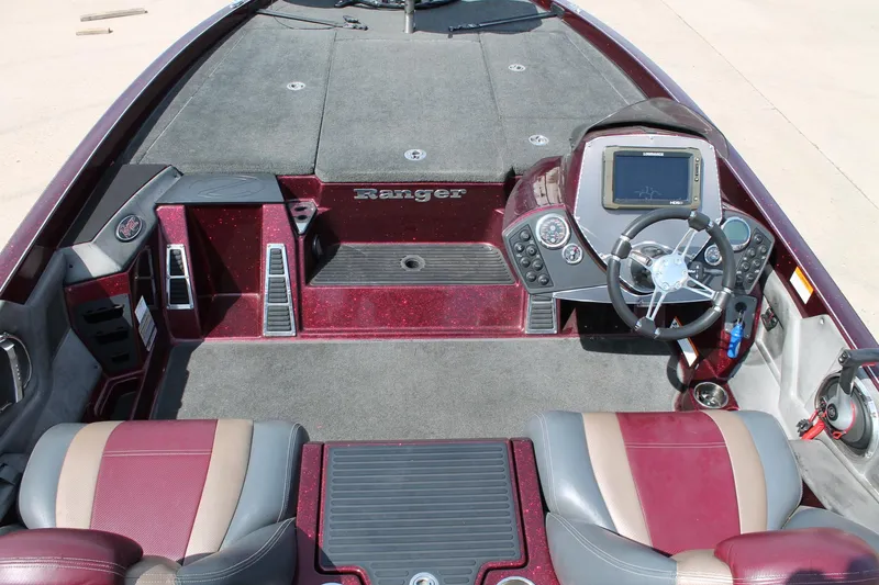 Slide: The Image of 2015 Ranger Z518C Comanche boat interior with steering wheel and dashboard controls. - 7
