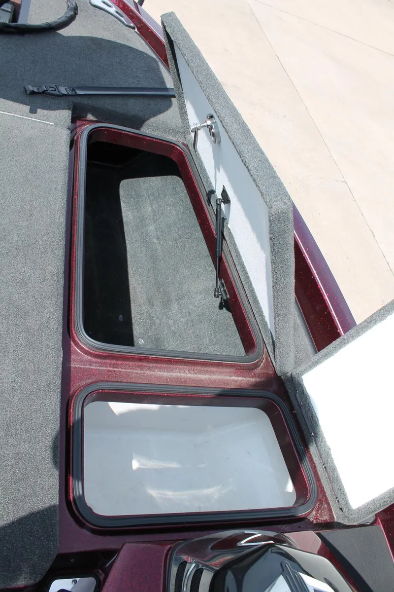 Slide: The Image of 2015 Ranger Z518C Comanche boat storage compartments with open lids. - 9