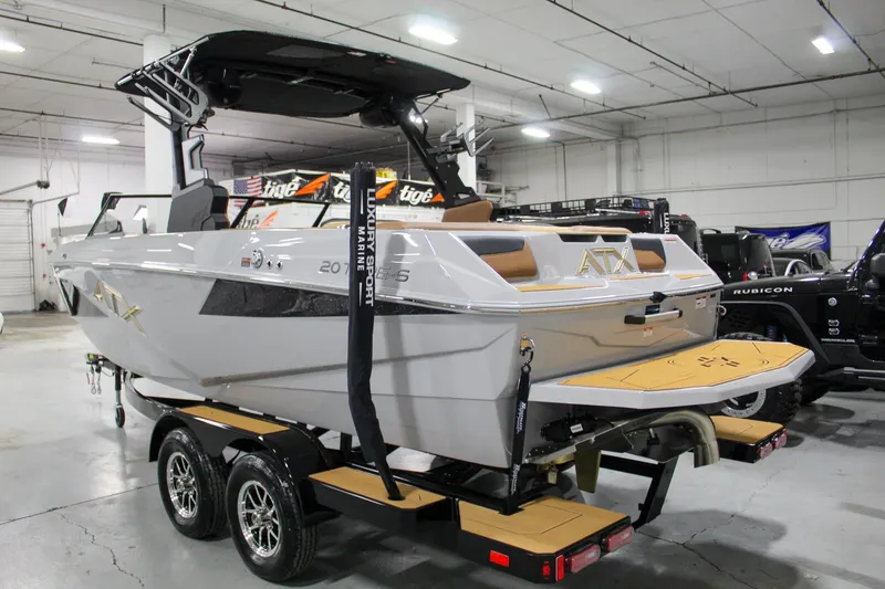Slide: The Image of 2025 ATX Surf Boats 20 Type-S on trailer in indoor showroom. - 2