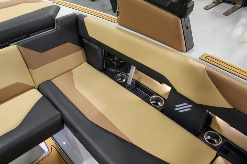 Slide: The Image of 2025 ATX Surf Boats 20 Type-S interior with tan and black seating, cup holders, and sleek design. - 20