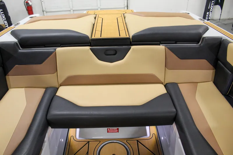 Slide: The Image of 2025 ATX Surf Boats 20 Type-S interior with tan and black seating. - 21