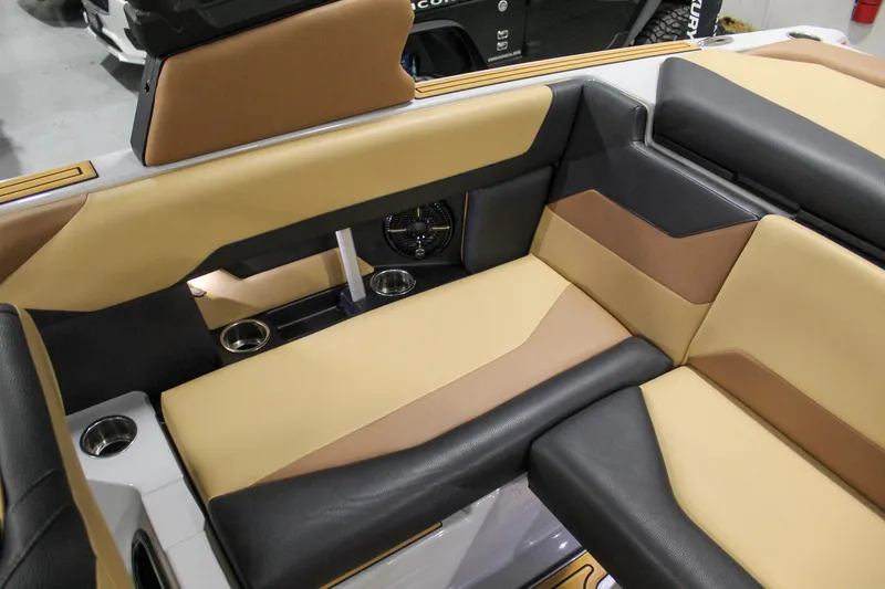 Slide: The Image of 2025 ATX Surf Boats 20 Type-S interior with tan and black seating, cup holders, and sleek design. - 22