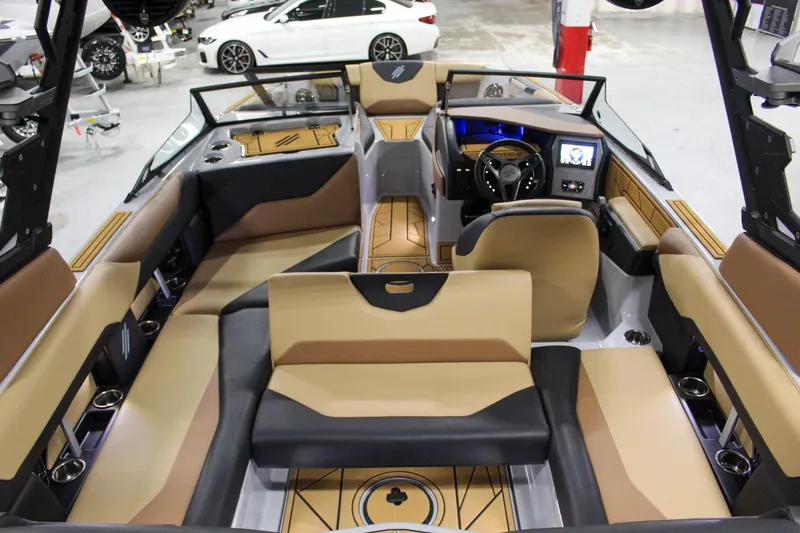 Slide: The Image of 2025 ATX Surf Boats 20 Type-S interior with tan and black seating, modern dashboard, and spacious layout. - 23