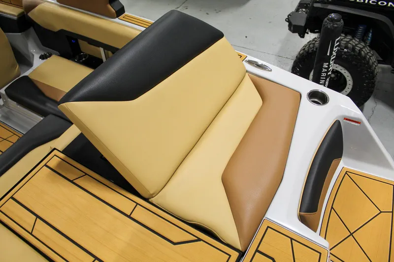 Slide: The Image of 2025 ATX Surf Boats 20 Type-S interior with tan and black seating, cup holder, and sleek design. - 25