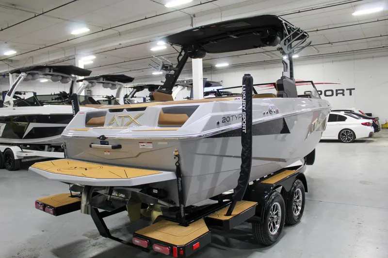Slide: The Image of 2025 ATX Surf Boats 20 Type-S in showroom, featuring sleek design and dual-axle trailer. - 5