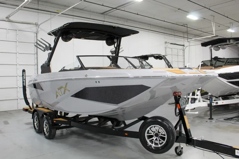 Slide: The Image of 2025 ATX Surf Boats 20 Type-S in showroom, sleek design on trailer. - 6