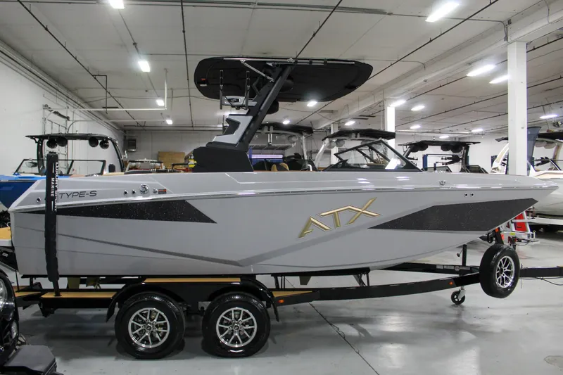 Slide: The Image of 2025 ATX Surf Boats 20 Type-S in showroom, sleek design, gray exterior, on trailer. - 7