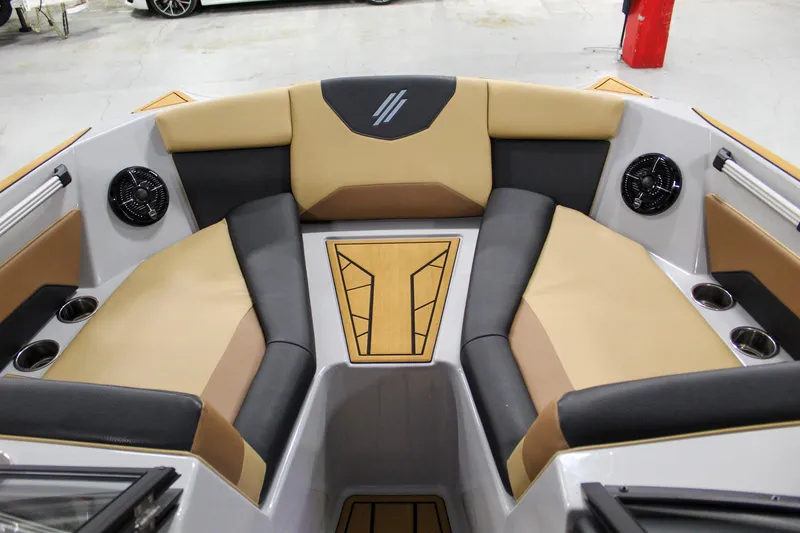 Slide: The Image of 2025 ATX Surf Boats 20 Type-S interior with tan and black seating, cup holders, and speakers. - 9