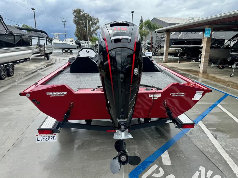 Slide: The Image of 2019 Tracker Pro Team 195 TXW boat with Mercury engine, parked in a marina. - 11