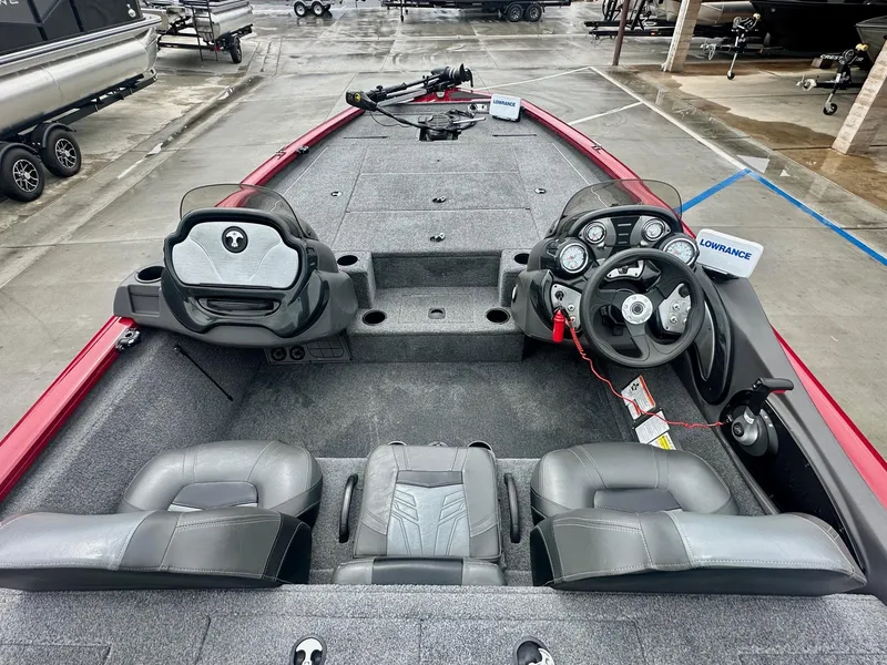 Slide: The Image of 2019 Tracker Pro Team 195 TXW boat interior with steering console and seating. - 4