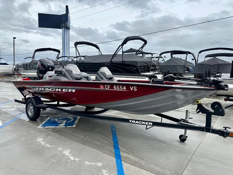 Slide: The Image of 2019 Tracker Pro Team 195 TXW boat on trailer in marina parking lot. - 9