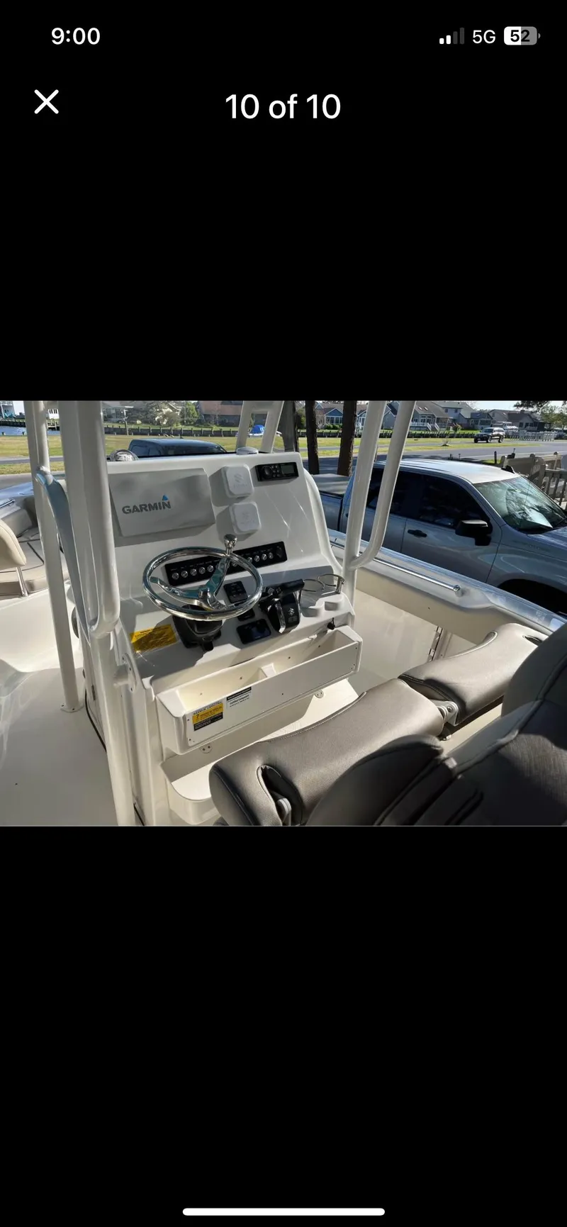 Slide: The Image of 2022 Key West 219 FS boat dashboard with steering wheel and controls. - 10