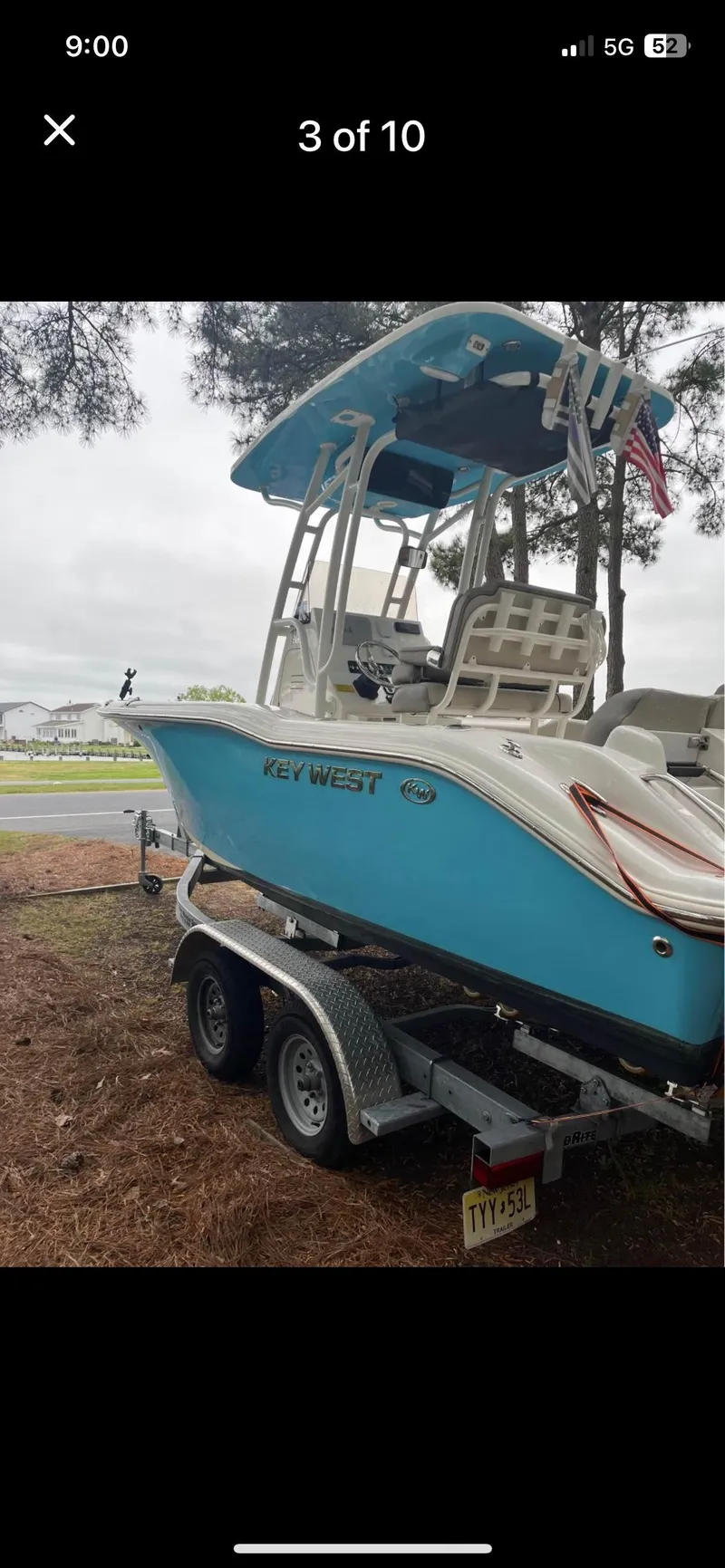 Slide: The Image of 2022 Key West 219 FS boat on trailer, parked outdoors. - 3