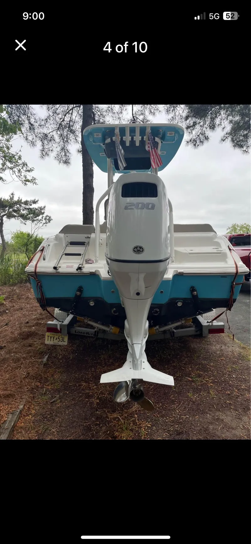 Slide: The Image of 2022 Key West 219 FS boat, rear view with outboard motor, parked outdoors. - 4