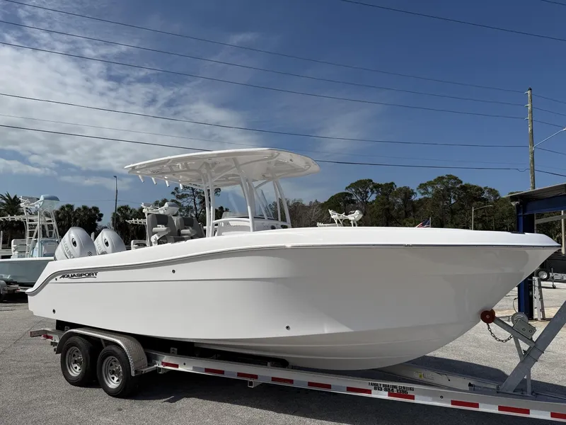 Slide: The Image of 2024 Aquasport 2500 CC boat on trailer under clear sky. - 1