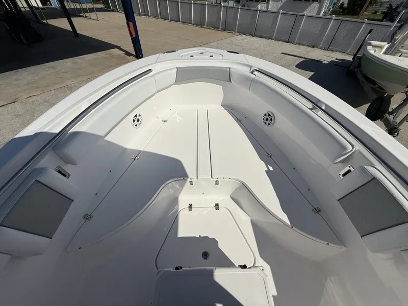 Slide: The Image of 2024 Aquasport 2500 CC boat interior with spacious seating and storage compartments. - 14