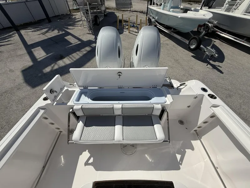 Slide: The Image of 2024 Aquasport 2500 CC boat with open storage compartment and seating, viewed from above. - 15