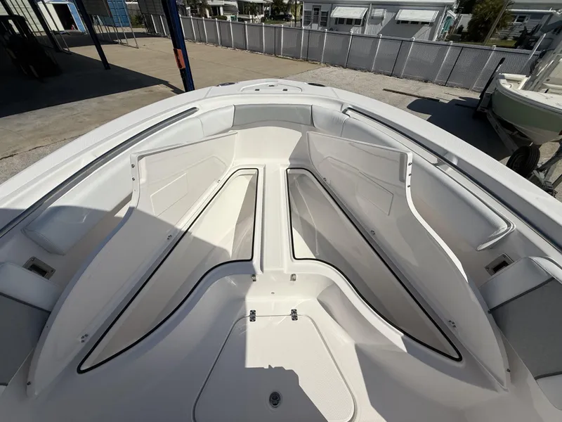 Slide: The Image of 2024 Aquasport 2500 CC boat interior with spacious seating and storage compartments. - 21