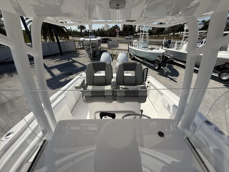 Slide: The Image of 2024 Aquasport 2500 CC boat interior with dual seats and steering console. - 33