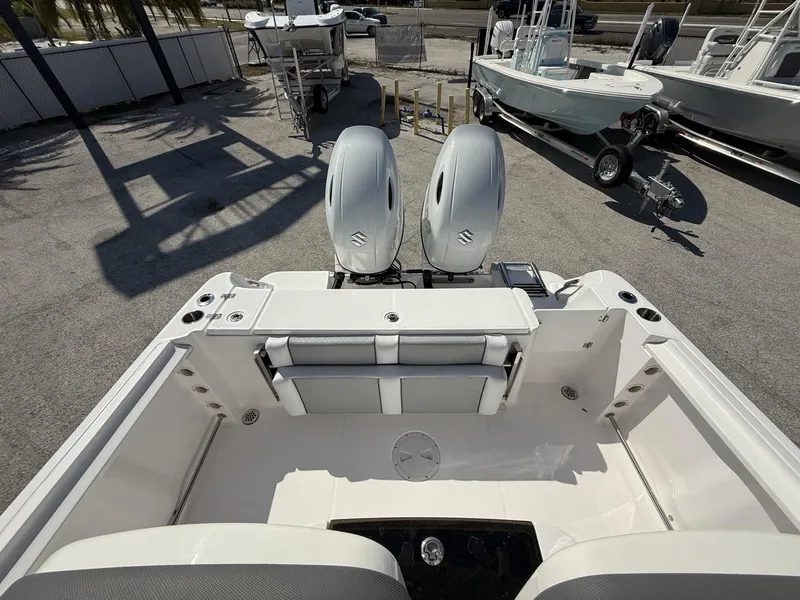 Slide: The Image of 2024 Aquasport 2500 CC boat with dual outboard engines, viewed from the rear deck. - 34
