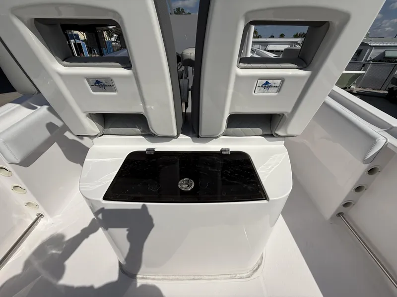 Slide: The Image of 2024 Aquasport 2500 CC boat interior with seating and storage compartment. - 35