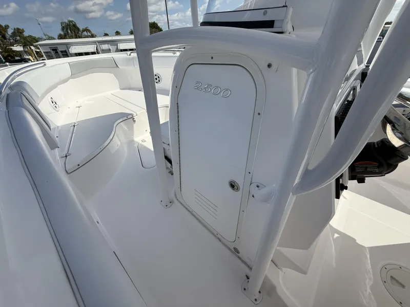 Slide: The Image of 2024 Aquasport 2500 CC boat interior with seating and storage compartment. - 37