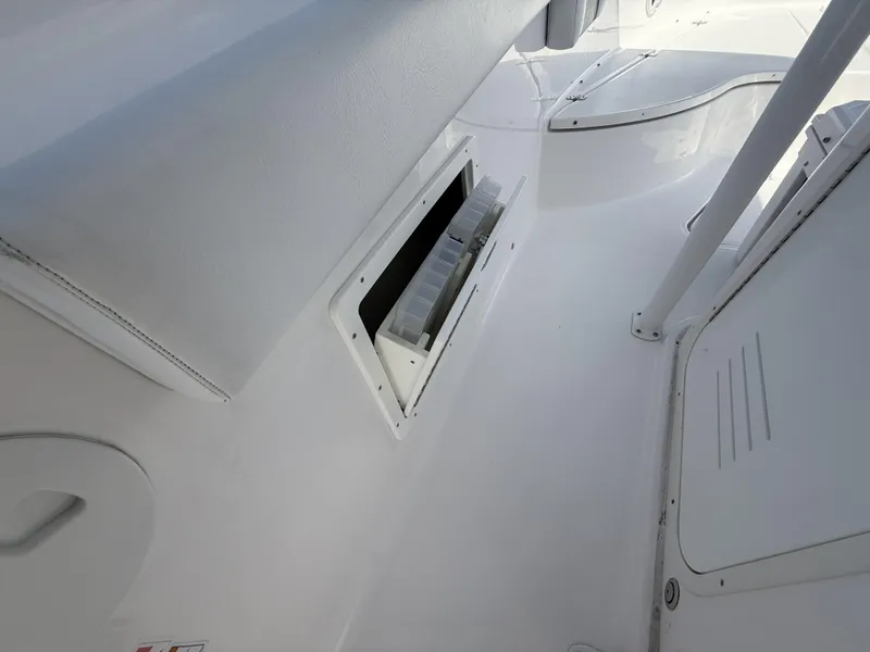 Slide: The Image of 2024 Aquasport 2500 CC interior storage compartment with sleek white design. - 39