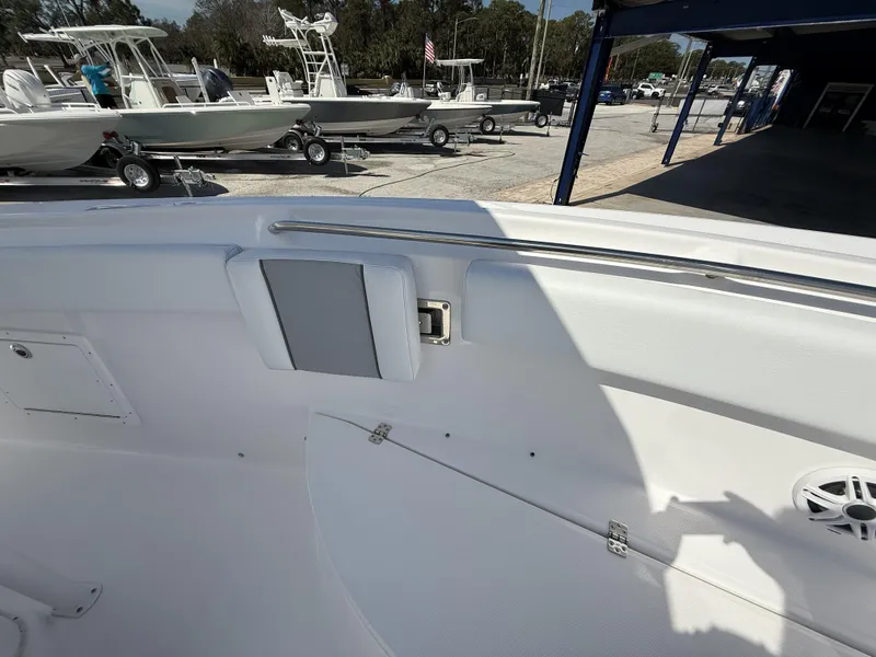 Slide: The Image of 2024 Aquasport 2500 CC boat interior with seating and storage compartments. - 42