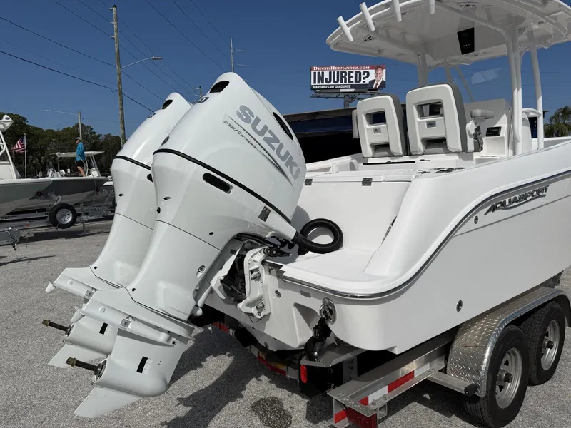 Slide: The Image of 2024 Aquasport 2500 CC boat with dual Suzuki engines on a trailer. - 5