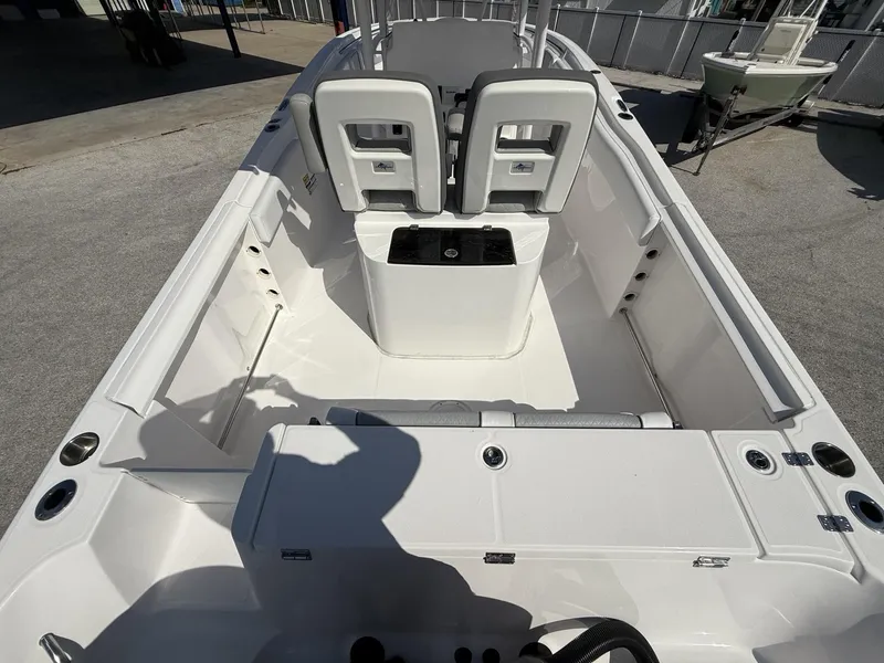 Slide: The Image of 2024 Aquasport 2500 CC boat interior with seating and storage compartments. - 8