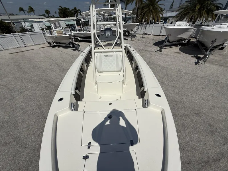 Slide: The Image of 2025 Pathfinder 2400 Open boat on display, surrounded by other boats and palm trees. - 11