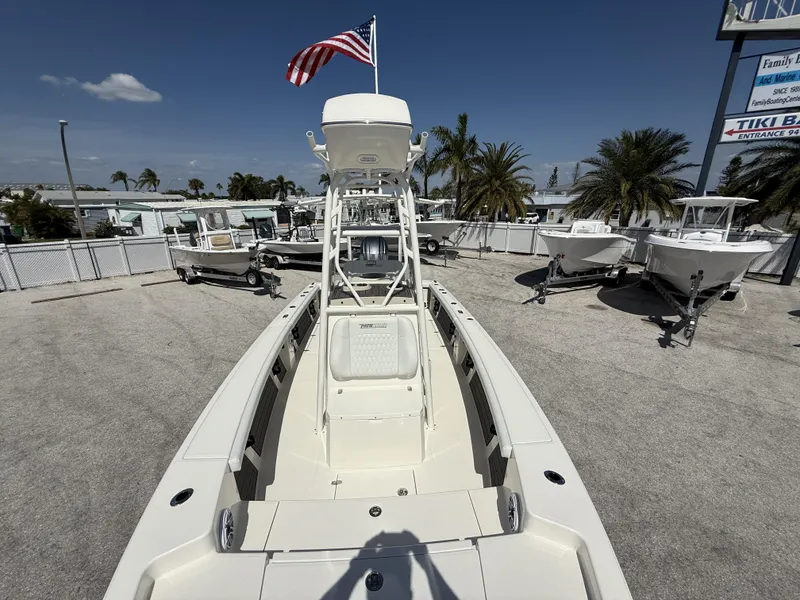 Slide: The Image of 2025 Pathfinder 2400 Open boat with American flag, displayed outdoors under clear sky. - 12
