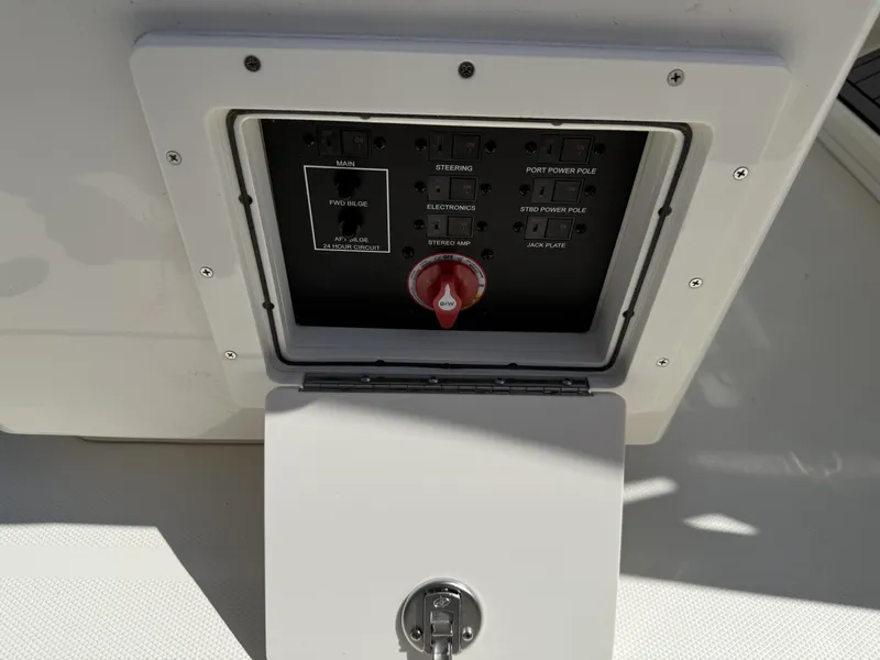 Slide: The Image of Control panel of 2025 Pathfinder 2400 Open boat, featuring various switches and a red dial. - 16
