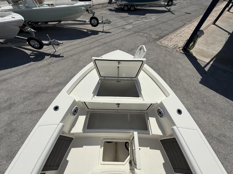 Slide: The Image of 2025 Pathfinder 2400 Open boat with open storage compartments, parked on a trailer. - 18